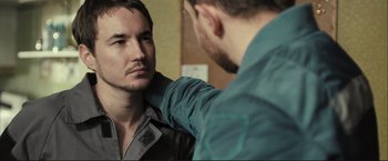 Movie still from “The Disappearance of Alice Creed” (2009), directed by J Blakeson – A man looking at another man's reflection in a mirror; Close Up shot, Over the shoulder angle