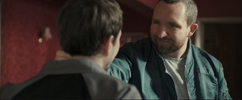 Movie still from “The Disappearance of Alice Creed” (2009), directed by J Blakeson – A man talking to another man in front of a wall; Close Up shot, Over the shoulder angle