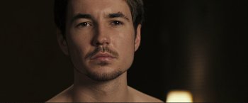Movie still from “The Disappearance of Alice Creed” (2009), directed by J Blakeson – A person with a mustache; Close Up shot, Over the shoulder angle