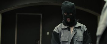 Movie still from “The Disappearance of Alice Creed” (2009), directed by J Blakeson – A man wearing a balaclava and a jacket; Close Up shot, Low angle