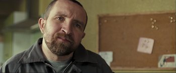 Movie still from “The Disappearance of Alice Creed” (2009), directed by J Blakeson – A person with a beard looking at the camera; Close Up shot, Low angle