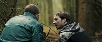 Movie still from “The Disappearance of Alice Creed” (2009), directed by J Blakeson – Two men in the woods one of them is looking at the other; Close Up shot, Over the shoulder angle