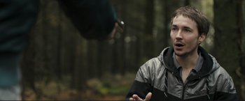 Movie still from “The Disappearance of Alice Creed” (2009), directed by J Blakeson – A person in a forest talking to a person in a jacket; Close Up shot, Over the shoulder angle