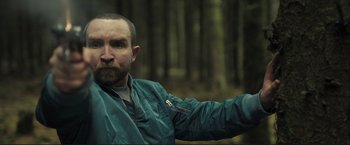 Movie still from “The Disappearance of Alice Creed” (2009), directed by J Blakeson – A person wearing a jacket in the woods; Close Up shot, Low angle