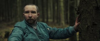 Movie still from “The Disappearance of Alice Creed” (2009), directed by J Blakeson – A person wearing a jacket near a forest; Close Up shot, Low angle