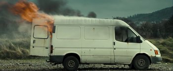 Movie still from “The Disappearance of Alice Creed” (2009), directed by J Blakeson – A white van is on fire on the side of the road; Wide shot, Low angle