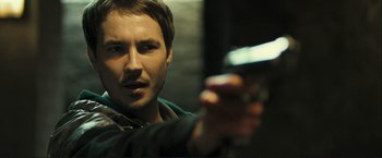 Movie still from “The Disappearance of Alice Creed” (2009), directed by J Blakeson – A person holding a gun; Close Up shot, Over the shoulder angle