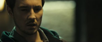 Movie still from “The Disappearance of Alice Creed” (2009), directed by J Blakeson – A man's face in a green jacket; Close Up shot, Over the shoulder angle