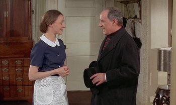 Movie still from “The Discreet Charm of the Bourgeoisie” (1972), directed by Luis Buñuel – An older man and a young woman are talking to each other; Medium shot, Over the shoulder angle
