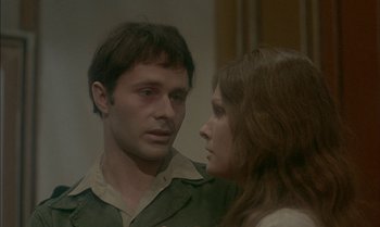 Movie still from “The Discreet Charm of the Bourgeoisie” (1972), directed by Luis Buñuel – A man and a woman looking at one another; Close Up shot, Over the shoulder angle