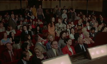 Movie still from “The Discreet Charm of the Bourgeoisie” (1972), directed by Luis Buñuel – A group of people sitting in a room; Wide shot, High angle