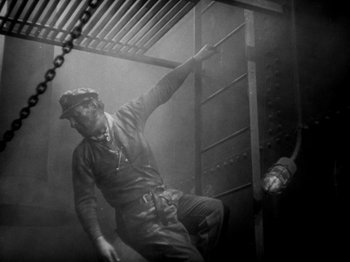 Movie still from “The Docks of New York” (1928), directed by Josef von Sternberg – A man climbing a ladder in a building; Medium shot, Low angle