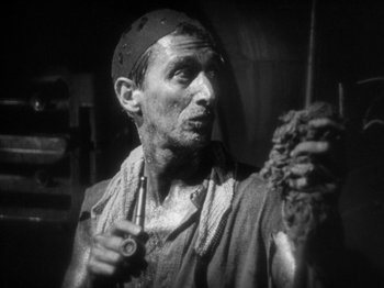 Movie still from “The Docks of New York” (1928), directed by Josef von Sternberg – An old man holding a bunch of food in his hand; Close Up shot, High angle