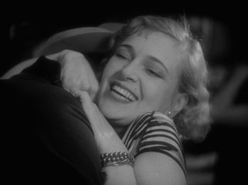 Movie still from “The Docks of New York” (1928), directed by Josef von Sternberg – An old photo of a woman hugging a man; Close Up shot, High angle