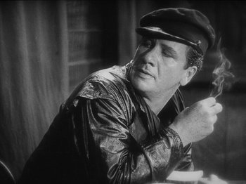 Movie still from “The Docks of New York” (1928), directed by Josef von Sternberg – Black and white photograph of a man wearing a hat; Close Up shot, Low angle