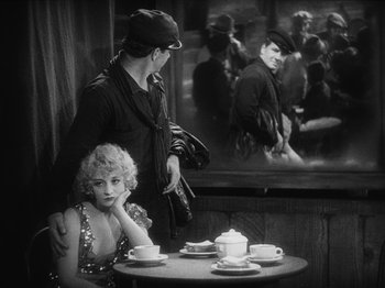 Movie still from “The Docks of New York” (1928), directed by Josef von Sternberg – A man and a woman sitting at a table; Medium shot, Over the shoulder angle