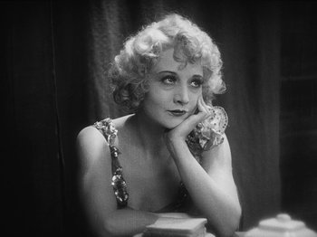 Movie still from “The Docks of New York” (1928), directed by Josef von Sternberg – An old photo of a woman posing for a picture; Close Up shot, High angle