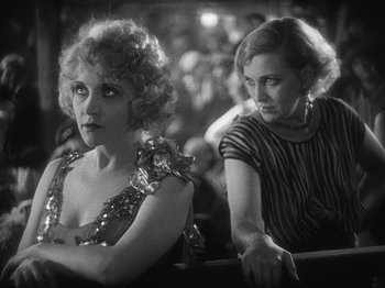 Movie still from “The Docks of New York” (1928), directed by Josef von Sternberg – Two women sitting next to each other on a stage; Close Up shot, Over the shoulder angle