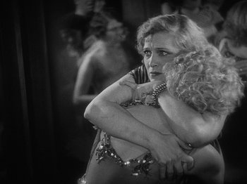 Movie still from “The Docks of New York” (1928), directed by Josef von Sternberg – A black and white photo of a woman holding a child; Medium shot, Low angle