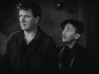 Movie still from “The Docks of New York” (1928), directed by Josef von Sternberg – A black and white photo of two men standing next to each other; Medium shot, Low angle