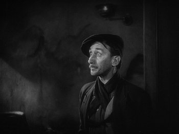Movie still from “The Docks of New York” (1928), directed by Josef von Sternberg – A man wearing a hat and a jacket; Close Up shot, Low angle