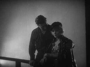 Movie still from “The Docks of New York” (1928), directed by Josef von Sternberg – A man and a woman standing next to a railing; Medium shot, Low angle
