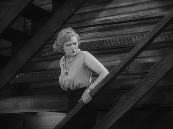 Movie still from “The Docks of New York” (1928), directed by Josef von Sternberg – An old photo of a woman leaning on a railing; Medium shot, Low angle