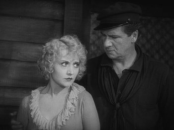 Movie still from “The Docks of New York” (1928), directed by Josef von Sternberg – An old photo of a man and a woman; Medium shot, High angle