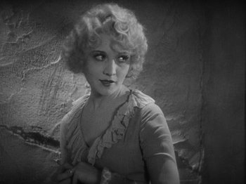 Movie still from “The Docks of New York” (1928), directed by Josef von Sternberg – An old black and white photo of a woman in a short dress; Close Up shot, High angle