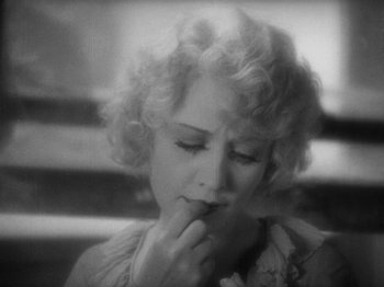Movie still from “The Docks of New York” (1928), directed by Josef von Sternberg – An old photo of a woman holding her hand to her mouth; Close Up shot, High angle