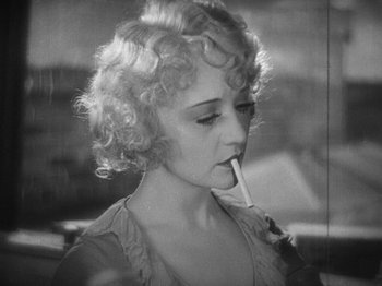 Movie still from “The Docks of New York” (1928), directed by Josef von Sternberg – A black - and - white photo of a woman smoking a cigarette; Close Up shot, High angle