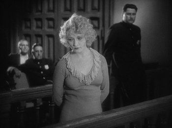 Movie still from “The Docks of New York” (1928), directed by Josef von Sternberg – An old photo of a woman standing in front of a judge; Medium shot, Over the shoulder angle