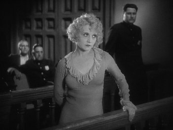 Movie still from “The Docks of New York” (1928), directed by Josef von Sternberg – A woman standing in front of a group of people; Medium shot, Low angle