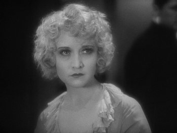 Movie still from “The Docks of New York” (1928), directed by Josef von Sternberg – An old black and white photo of a woman with curly hair; Close Up shot, High angle