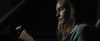 Movie still from “The Domestics” (2018), directed by Mike P. Nelson – A woman with long blonde hair looking at the camera; Close Up shot, Over the shoulder angle