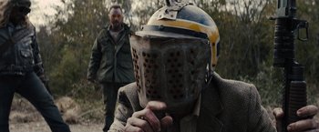 Movie still from “The Domestics” (2018), directed by Mike P. Nelson – A man with a helmet on his head; Close Up shot, Over the shoulder angle
