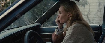 Movie still from “The Domestics” (2018), directed by Mike P. Nelson – A woman sitting in the driver's seat of a car; Close Up shot, Over the shoulder angle