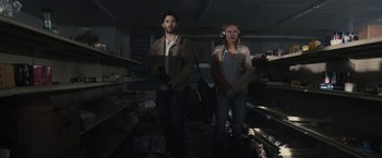 Movie still from “The Domestics” (2018), directed by Mike P. Nelson – A man and a woman standing next to each other in a room; Medium shot, Low angle