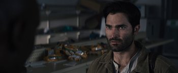 Movie still from “The Domestics” (2018), directed by Mike P. Nelson – A person wearing a brown jacket; Close Up shot, Over the shoulder angle