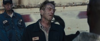 Movie still from “The Domestics” (2018), directed by Mike P. Nelson – A person wearing a shirt and jacket; Close Up shot, Over the shoulder angle