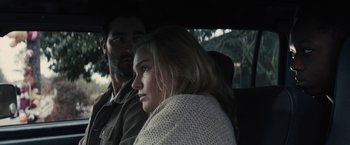 Movie still from “The Domestics” (2018), directed by Mike P. Nelson – A man and a woman sitting in the back of a car; Close Up shot, Over the shoulder angle