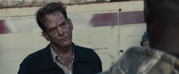 Movie still from “The Domestics” (2018), directed by Mike P. Nelson – A person wearing a jacket; Close Up shot, Over the shoulder angle