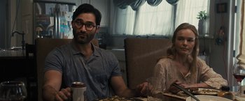 Movie still from “The Domestics” (2018), directed by Mike P. Nelson – A man sitting at a dinner table with a woman; Medium shot, Over the shoulder angle
