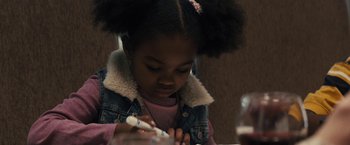 Movie still from “The Domestics” (2018), directed by Mike P. Nelson – A little girl is writing on a piece of paper; Close Up shot, Over the shoulder angle