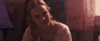 Movie still from “The Domestics” (2018), directed by Mike P. Nelson – A beautiful young lady sitting in front of a window; Close Up shot, Over the shoulder angle