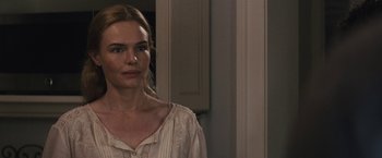 Movie still from “The Domestics” (2018), directed by Mike P. Nelson – A woman standing in front of a door; Close Up shot, Over the shoulder angle