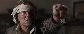 Movie still from “The Domestics” (2018), directed by Mike P. Nelson – A man with a blindfold on his head; Close Up shot, Over the shoulder angle