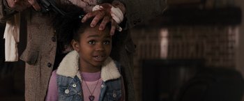 Movie still from “The Domestics” (2018), directed by Mike P. Nelson – A little girl getting her hair brushed by an adult; Close Up shot, Over the shoulder angle