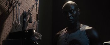 Movie still from “The Domestics” (2018), directed by Mike P. Nelson – A man standing in front of a mirror; Close Up shot, Low angle