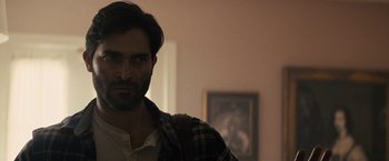 Movie still from “The Domestics” (2018), directed by Mike P. Nelson – A person wearing a plaid shirt; Close Up shot, Over the shoulder angle